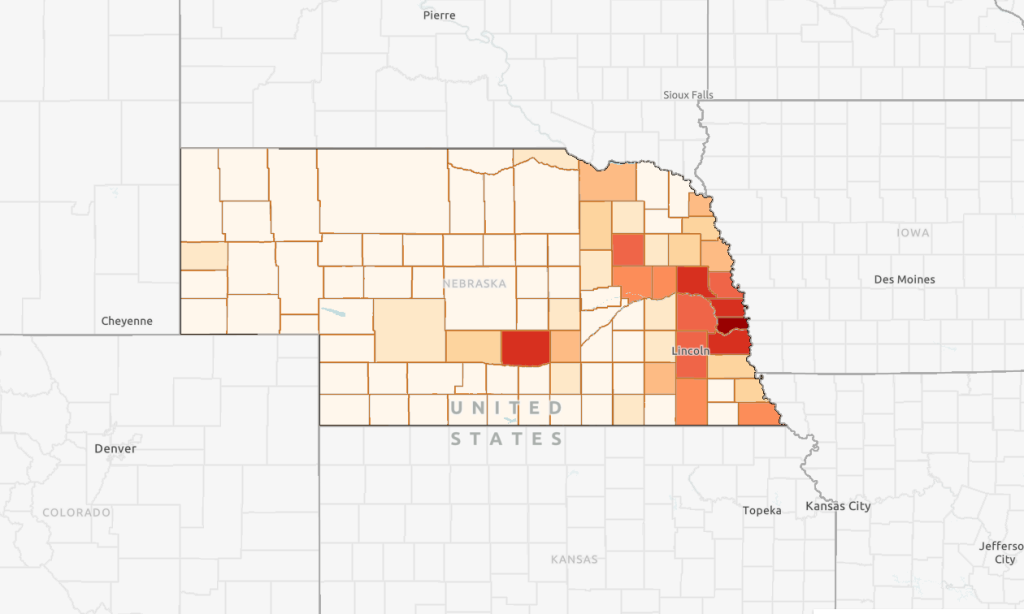 A map of Nebraska showing flood insurance payout by county in dollars from 1983 through 2023. Counties with darker shades of red had larger payouts than counties in lighter shades of red.